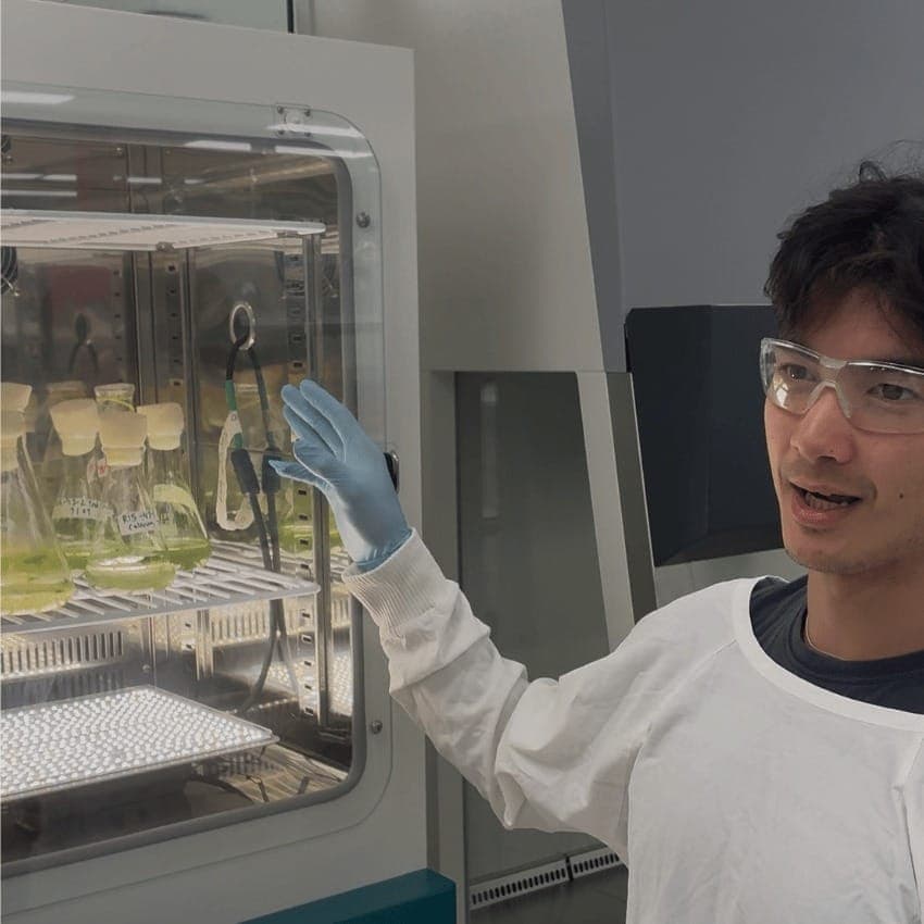 Co-Founder John Phipps in the lab with algae flasks